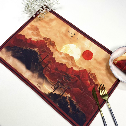 Placemat with artistic design of a ship and sunset on a white surface.
