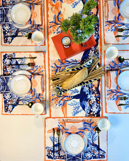 Decorative table setting with patterned placemats, plates, and cutlery on a neutral background.