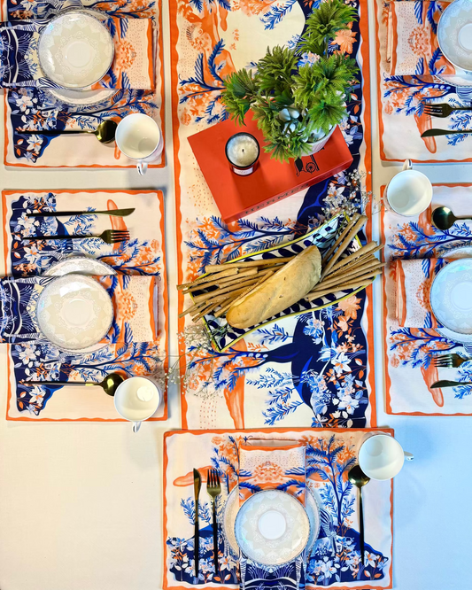 Decorative table setting with patterned placemats, plates, and cutlery on a neutral background.